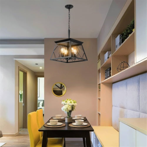 Modern interior design with a black pendant light, yellow chairs, and a vase of flowers.