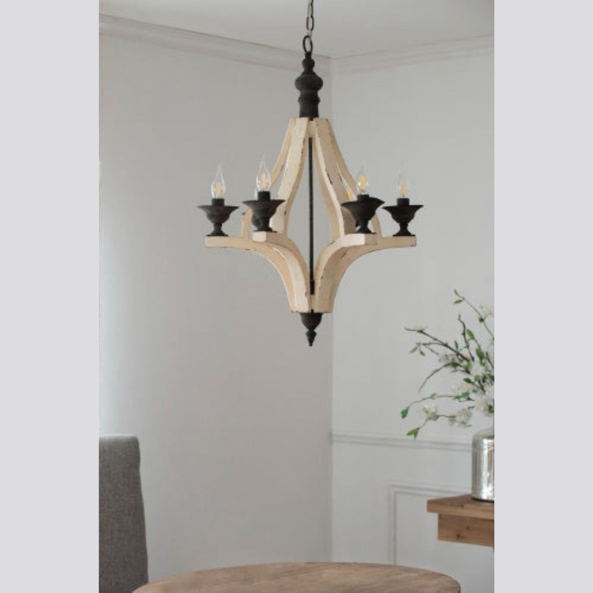 Wooden chandelier hanging in a room with a neutral color scheme.