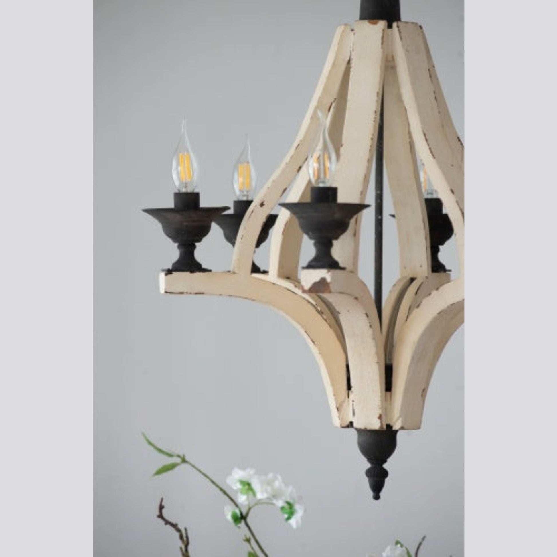 Wooden chandelier with black accents on a gray background