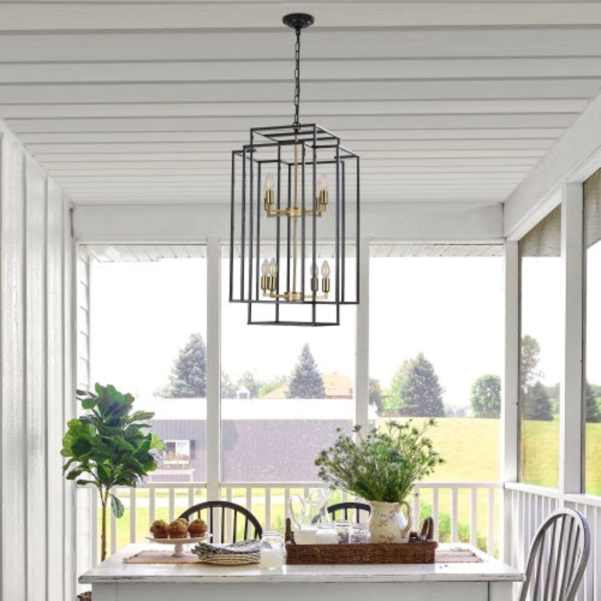 Chandelier hanging above a dining table with a view of trees outside
