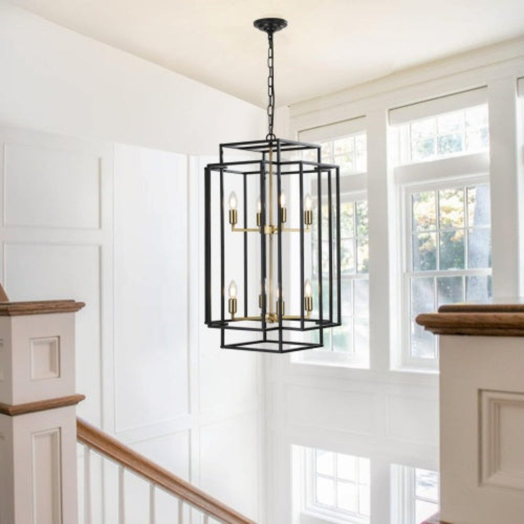Black pendant light fixture hanging in a room with white walls and large windows.