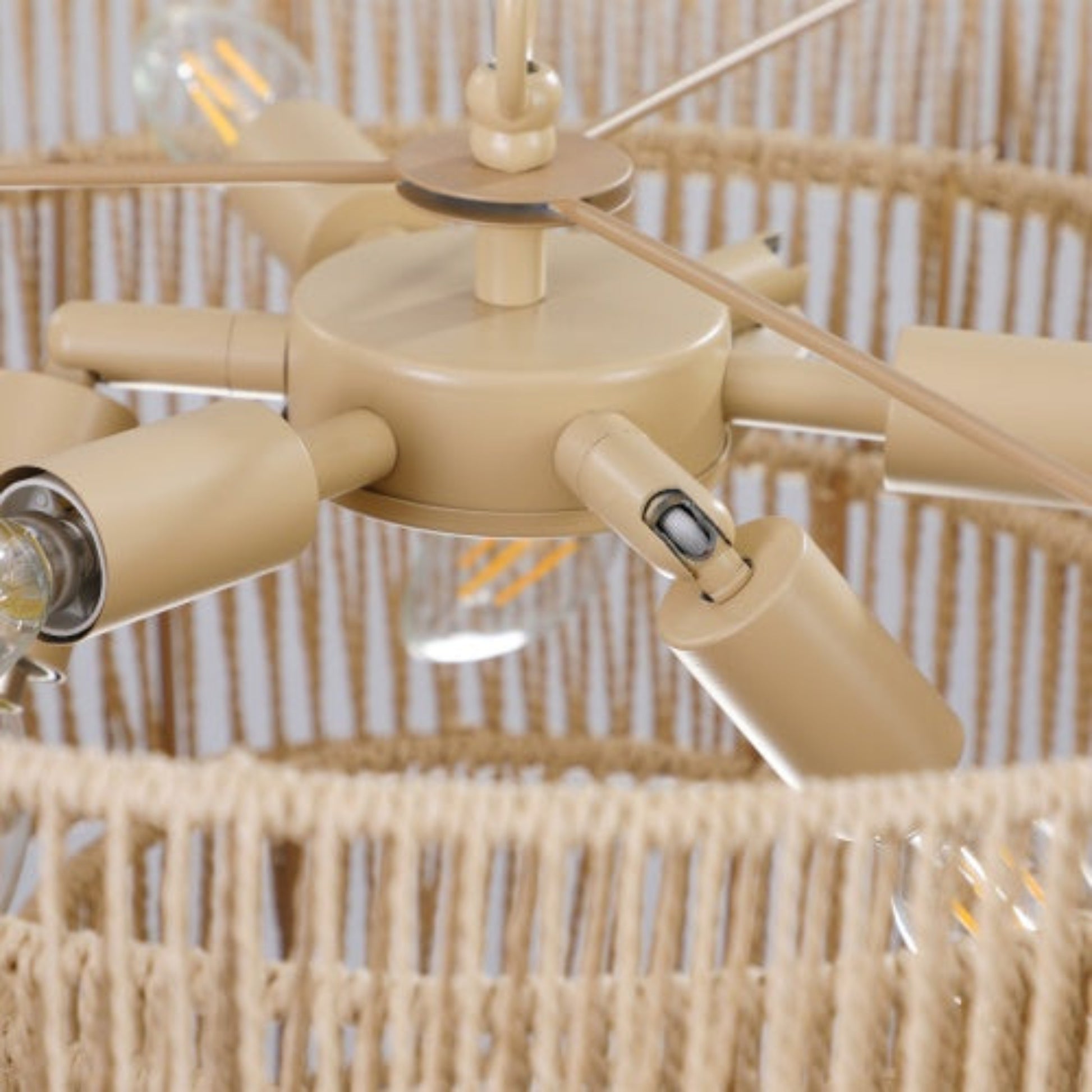 Beige ceiling fan with light bulbs against a wicker background