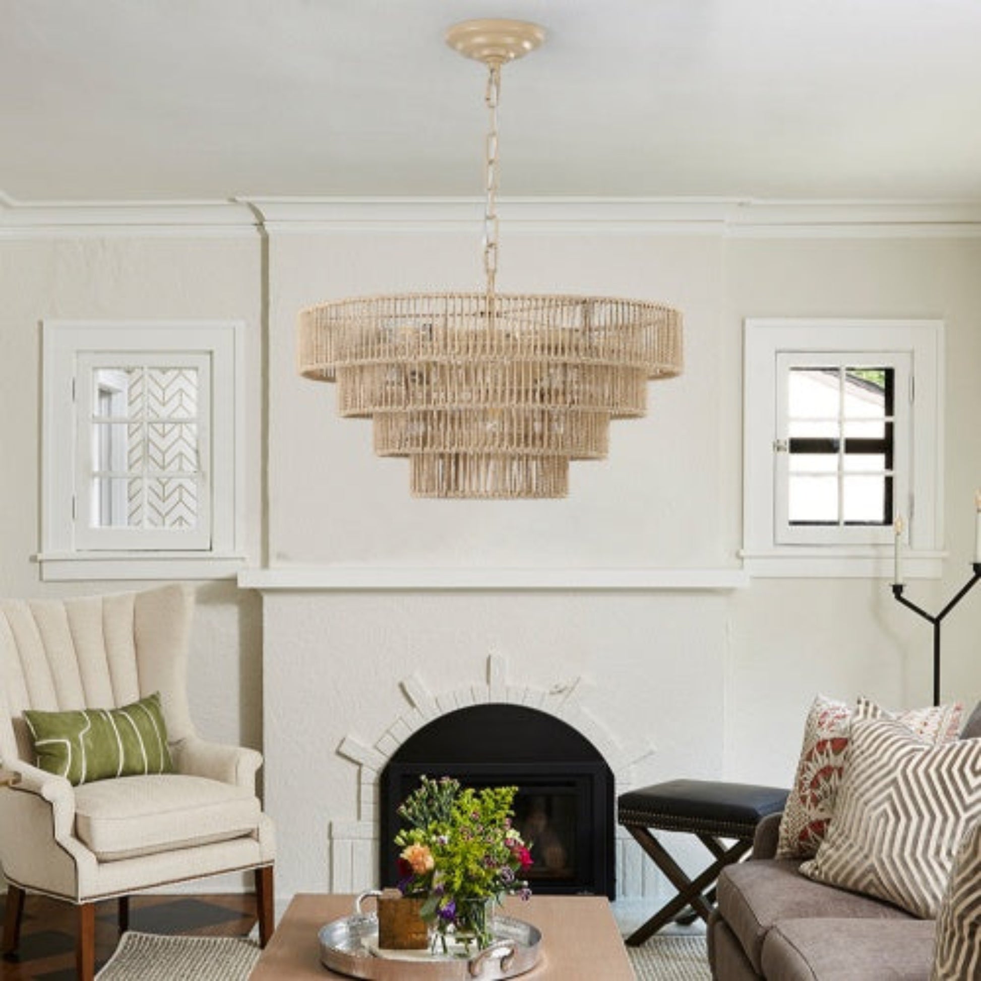 Living room with a chandelier, fireplace, and decorative items.