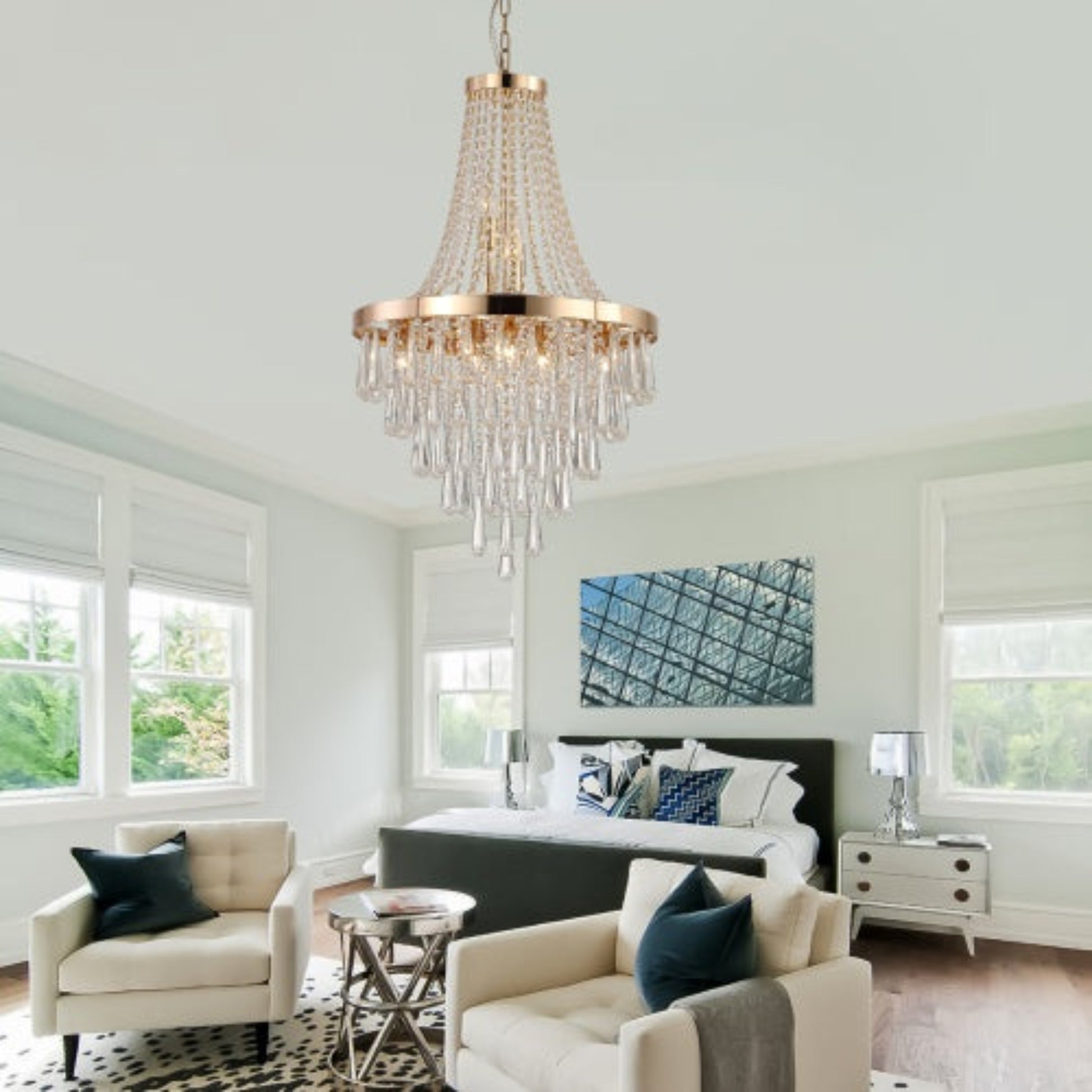 Modern bedroom with a chandelier, bed, and armchair.