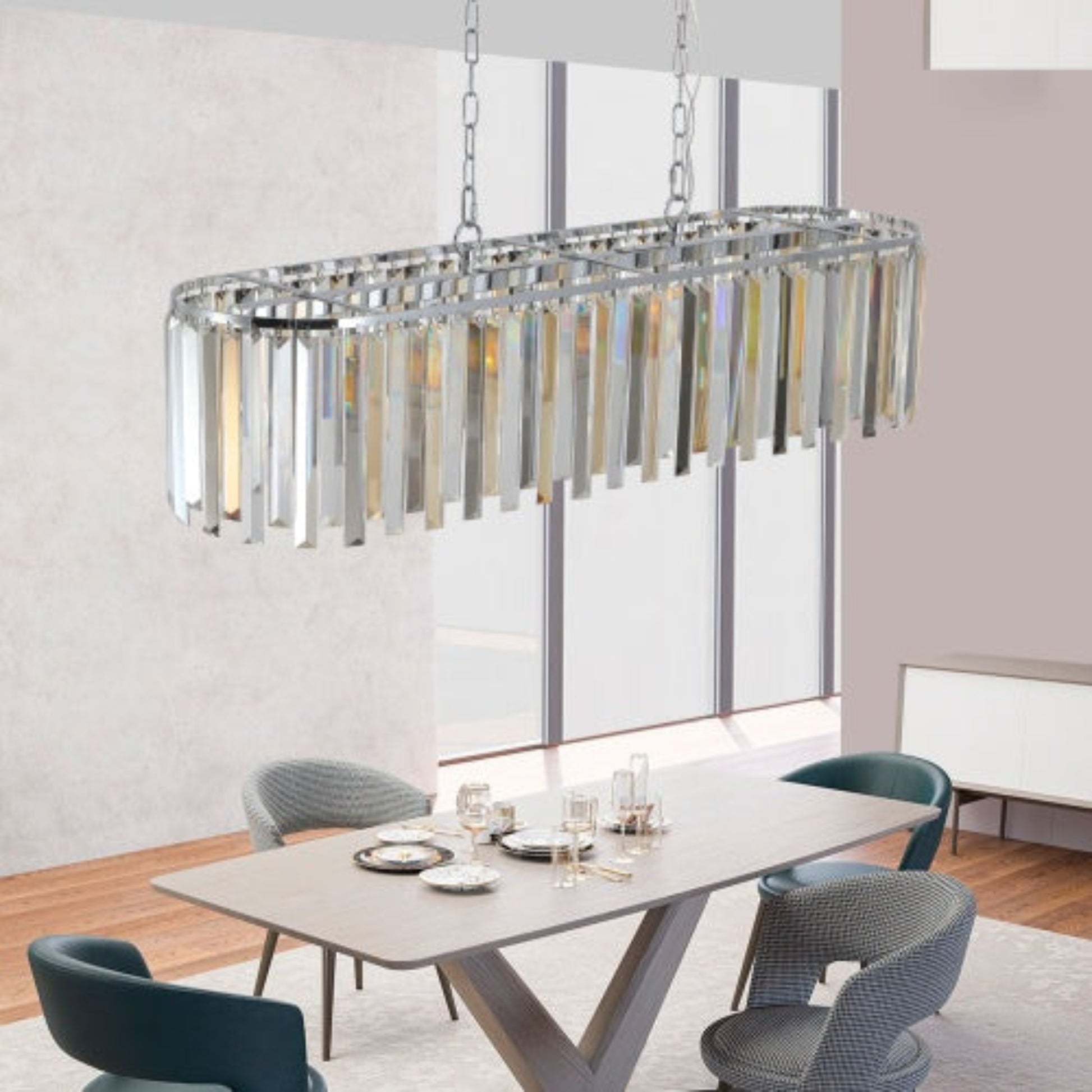 Modern chandelier hanging above a dining table with chairs in a well-lit room.