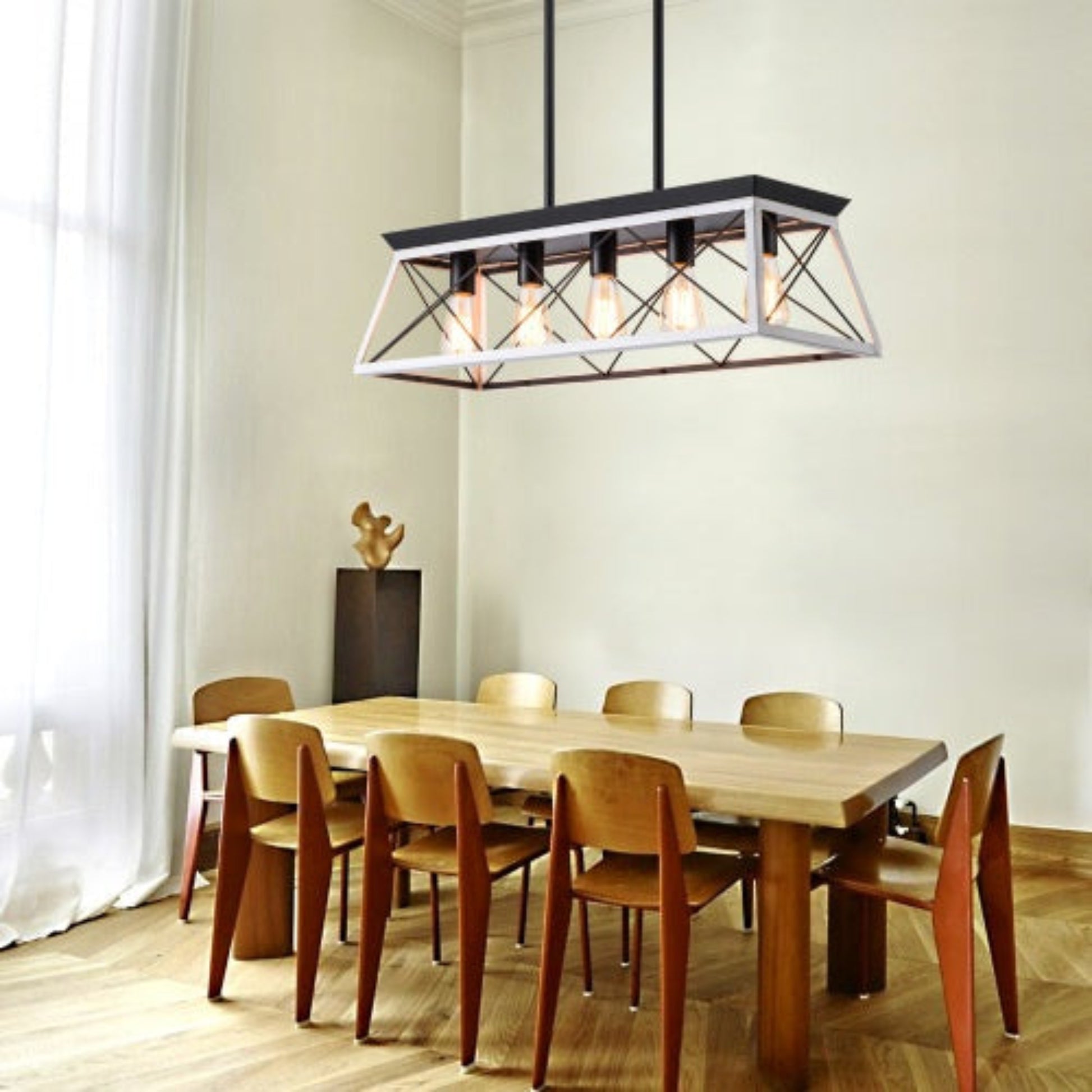 Dining room with wooden table and chairs under a modern pendant light.