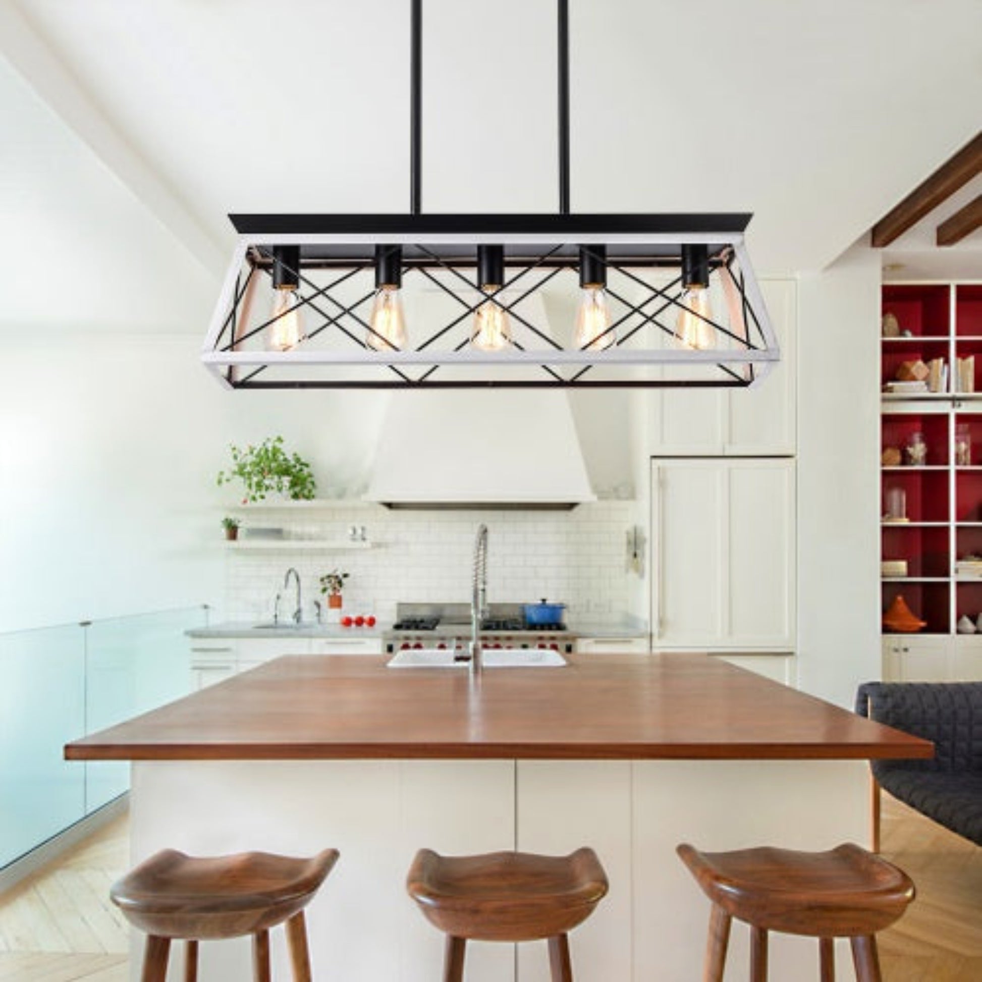 Modern kitchen with a wooden island and pendant light fixture.