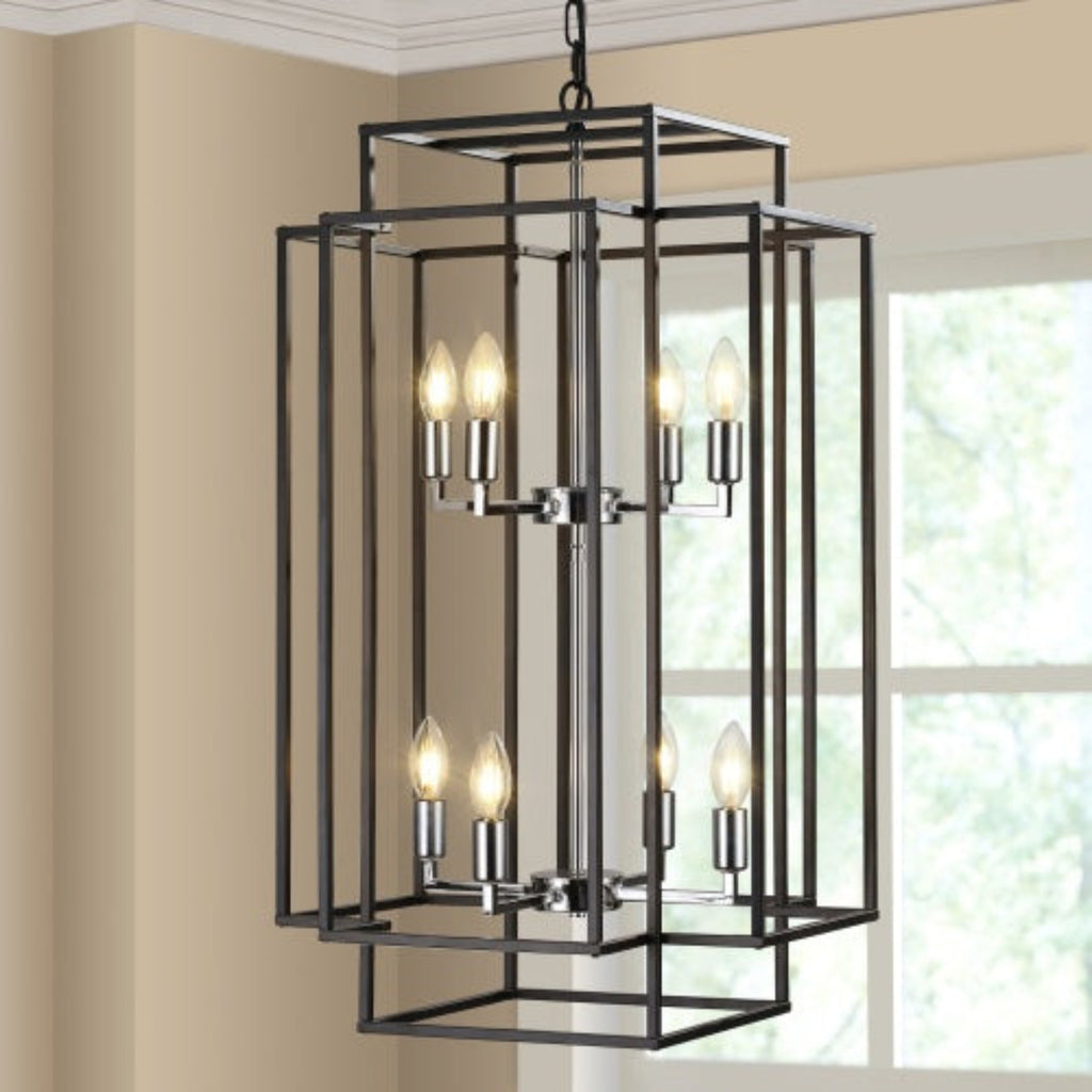 Modern black chandelier hanging in a room with beige walls and a window.
