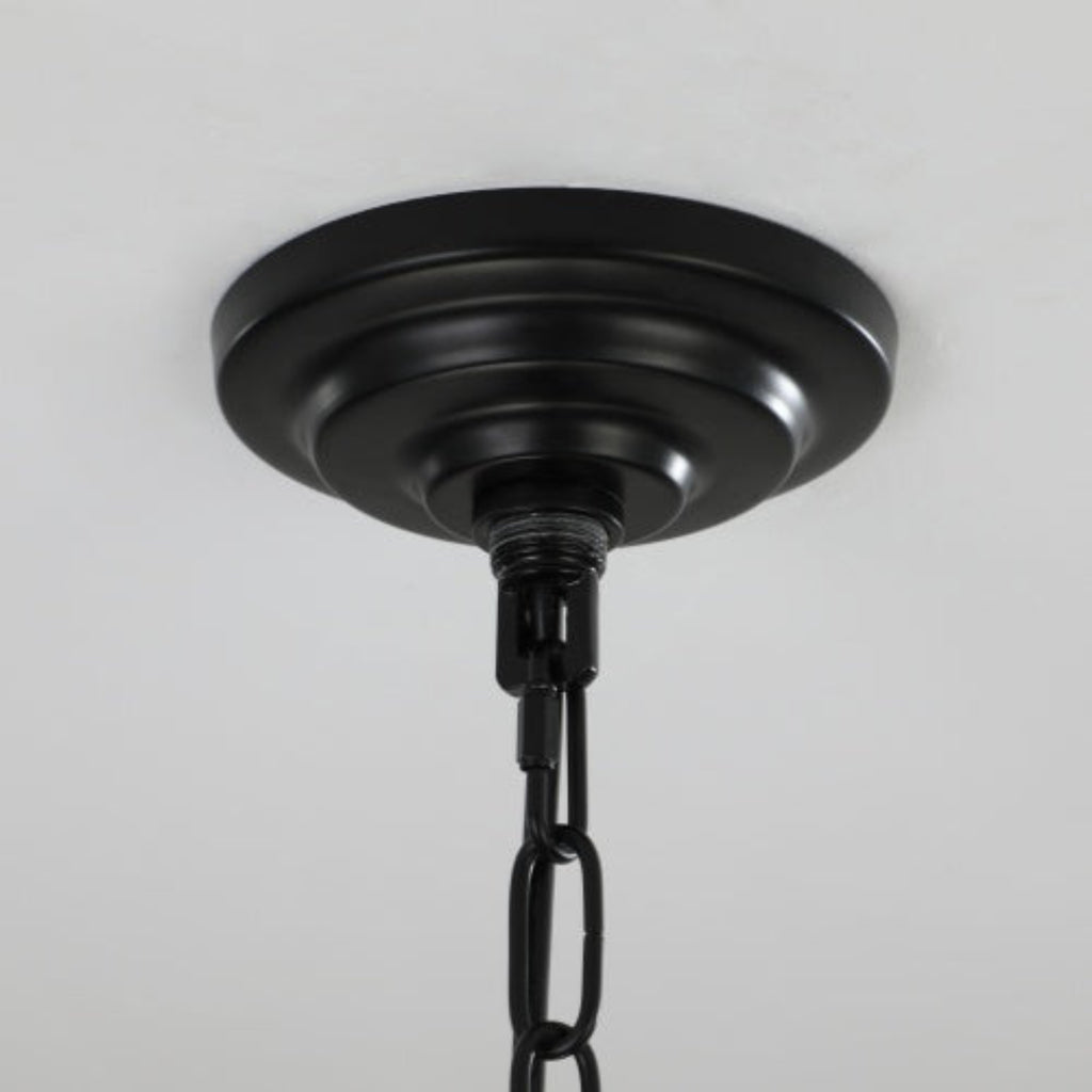 Black ceiling light fixture on a gray background