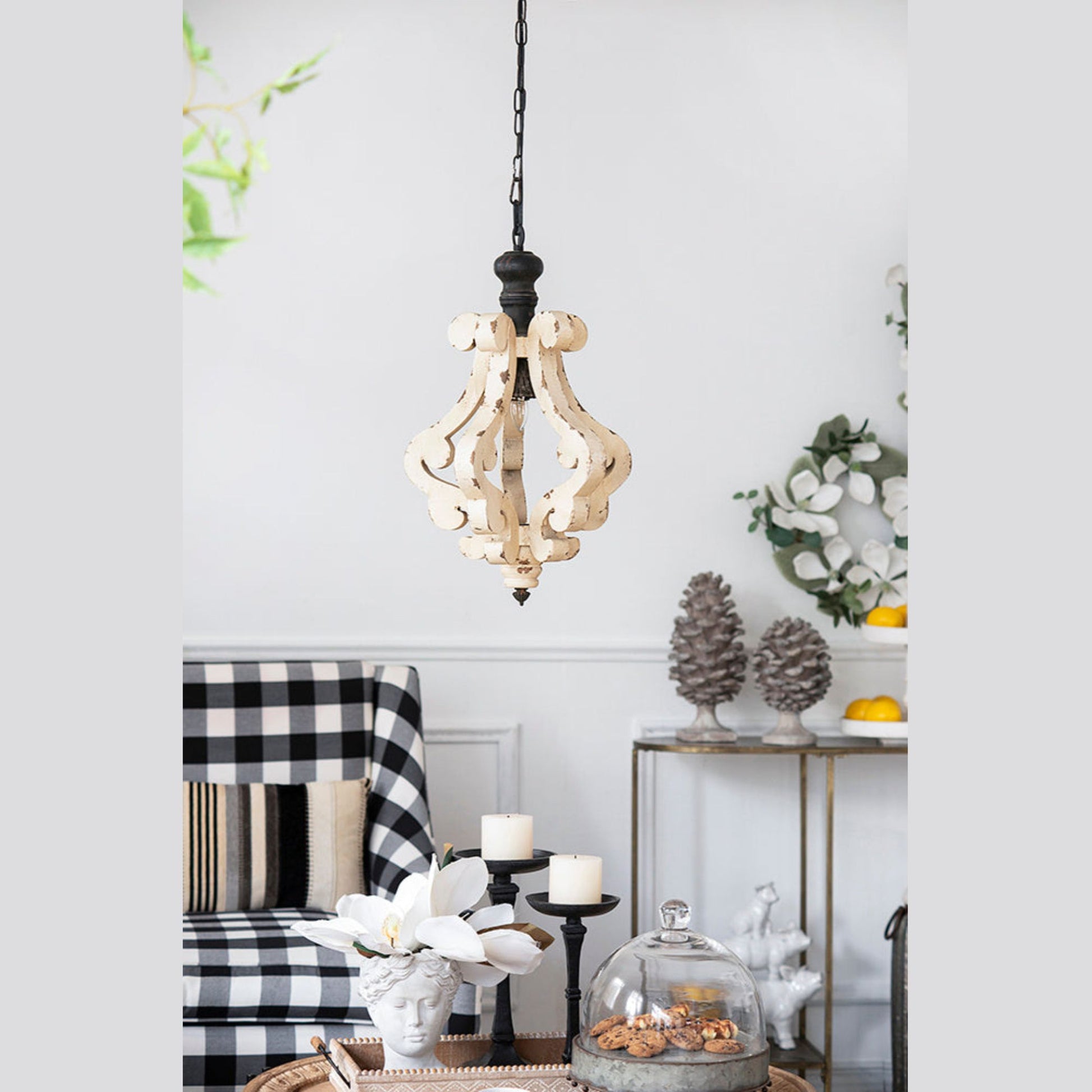 Living room with checkered armchair, decorative table, and pendant light.