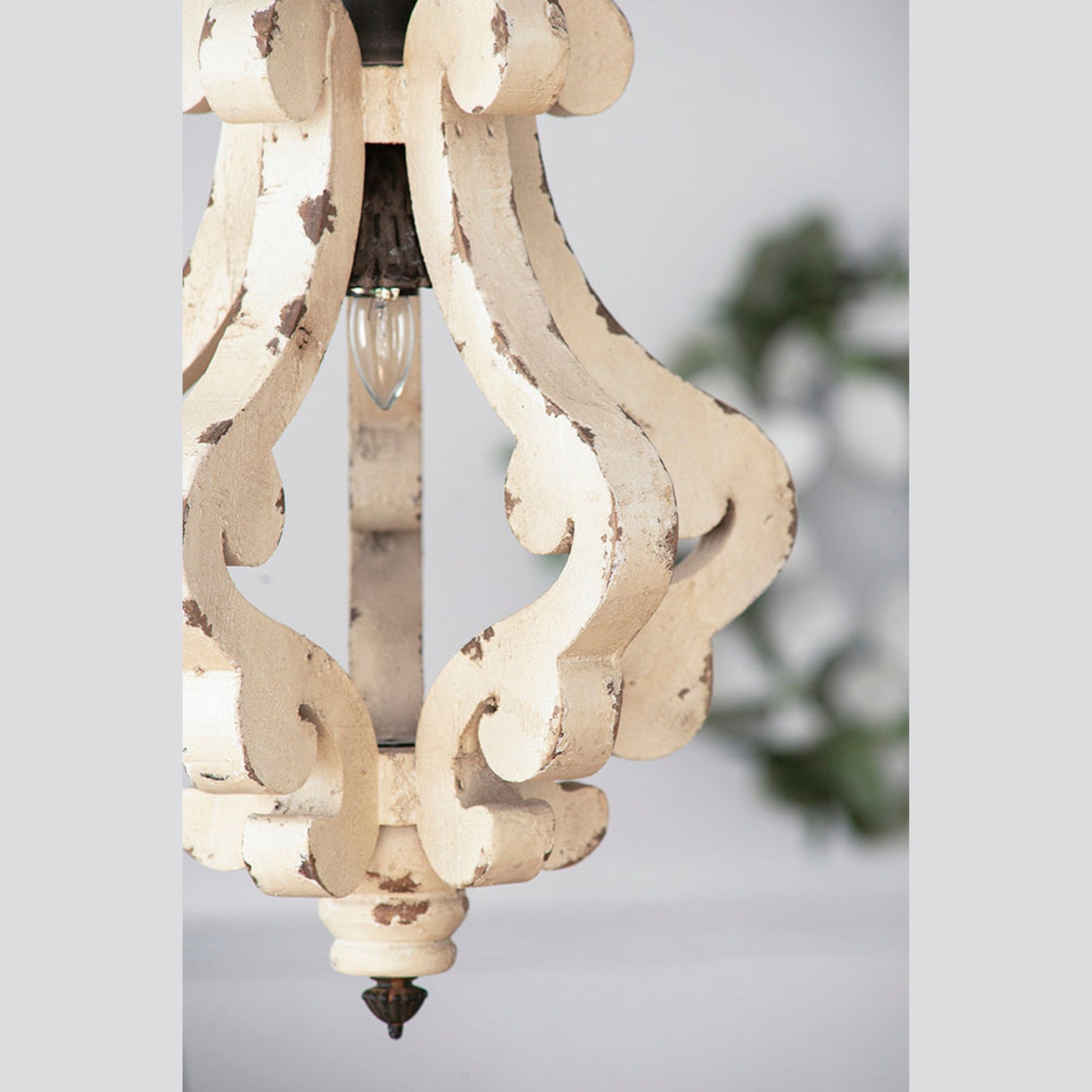 Decorative chandelier with intricate design on a light background